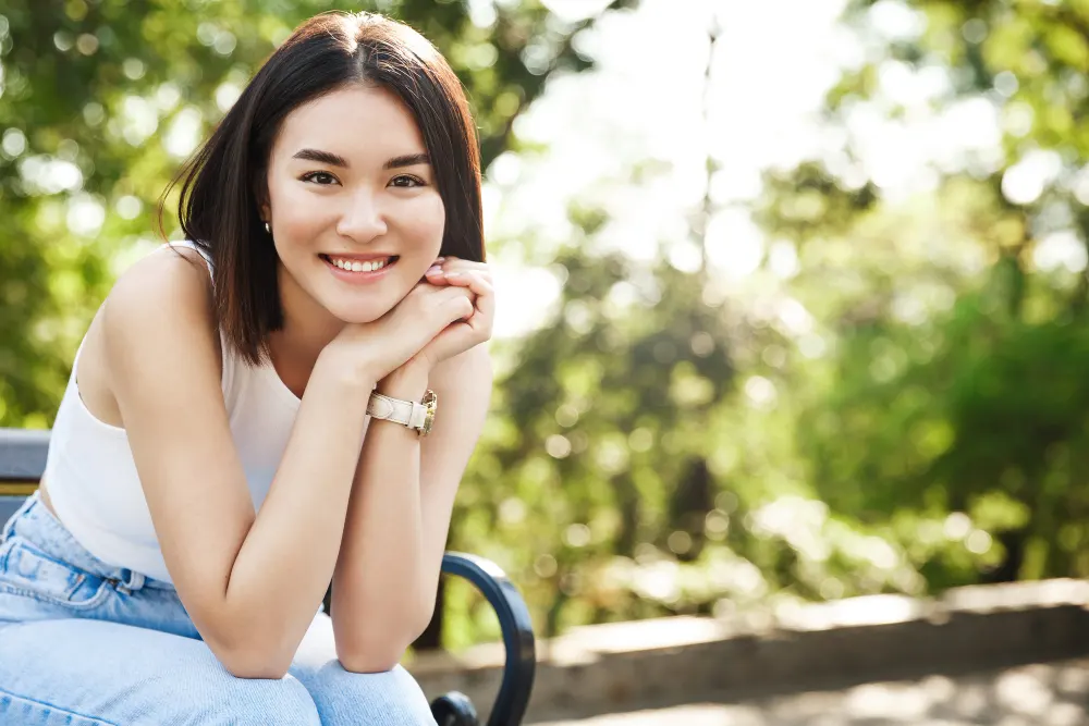 beautiful asian woman sitting bench smiling